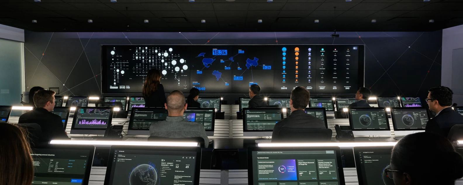 Analysts monitoring dashboards in a security operations room